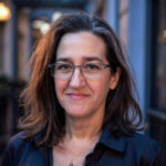 a kind woman wearing glasses